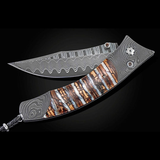 William Henry KnifeKnife Frame Type: 'Twist' damascus steelFrame Engraver: Chad NicholsBlade Type: 'Wave' damascus steel with an extra strong core of VG-10Scale/Inlay: 10,000 year-old fossil Woolly Mammoth toothNumber: 001/250Gemstones/Embelli