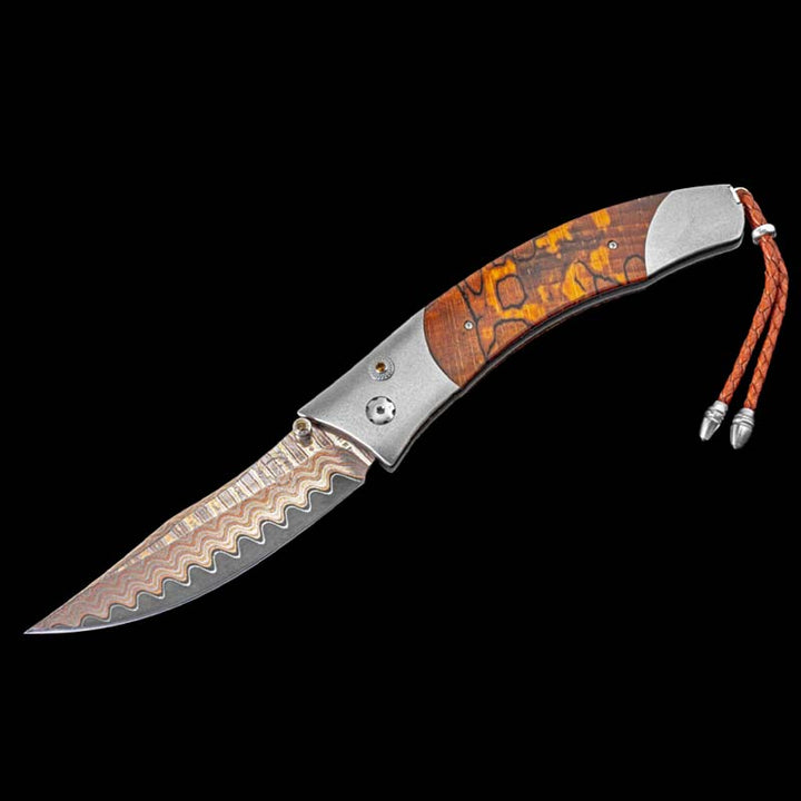 William Henry Knife
Knife Frame Type: aerospace grade titanium
Blade Type: Copper Wave' damascus steel with a core of VG-5.
Scale/Inlay: orange spalted Beech wood
Number: 18/250
Gemstones/Embellishments: citrine gemstones.